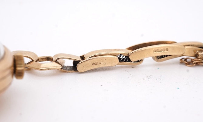 A lady's 9ct gold Record manual wind wrist watch, with Arabic dial and subsidiary seconds, on a 9ct gold bracelet, gross weight 16 grams. Condition - fair